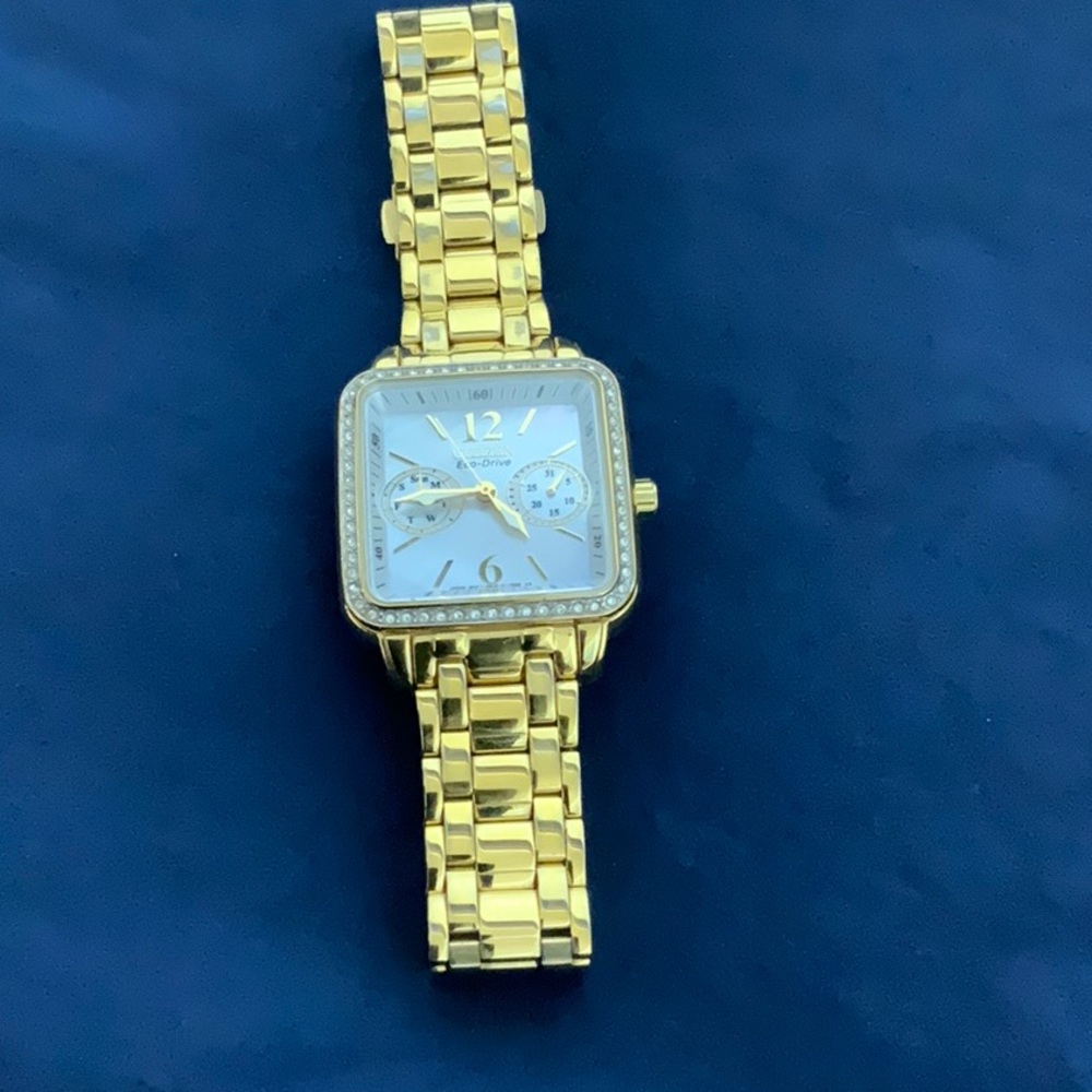 Women’s Bulova Watch, mother of pearl face, square, crystal bezel, gold metal